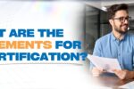 A professional setting where two people, a man and a woman, are engaged in a discussion, likely reviewing documents. The text overlay reads, "What are the requirements for FIDIC Certification?"