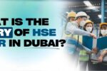 Graphic featuring a group of workers in safety gear reviewing a document in an industrial setting, accompanied by the text 'What is the salary of HSE officer in Dubai?' with the Zabeel International logo and website URL (zabeel-international.com).