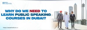 Three diverse professionals, dressed in formal attire, walk together in an urban setting with the Dubai skyline in the background. The bold text on the left reads, "Why do we need to learn public speaking courses in Dubai?" accompanied by Zabeel International Institute’s logo and website link, highlighting the importance of public speaking skills for professionals in Dubai.