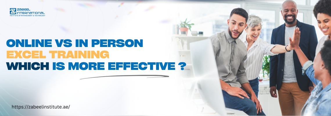 A cheerful group of professionals interacting around a computer screen in a bright office, with the text 'Online vs In Person Excel Training – Which is More Effective?' displayed next to the Zabeel International logo and website URL.