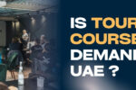 A classroom setting with students seated and a woman presenting a slideshow titled "What is a Role Profile?" on a projector screen. On the right, bold text reads: “IS TOURISM COURSE A DEMAND IN UAE?” with “TOURISM COURSE” highlighted in yellow. The Zabeel Institute logo and website link (https://zabeel-international.com/) appear on the top and bottom right respectively.